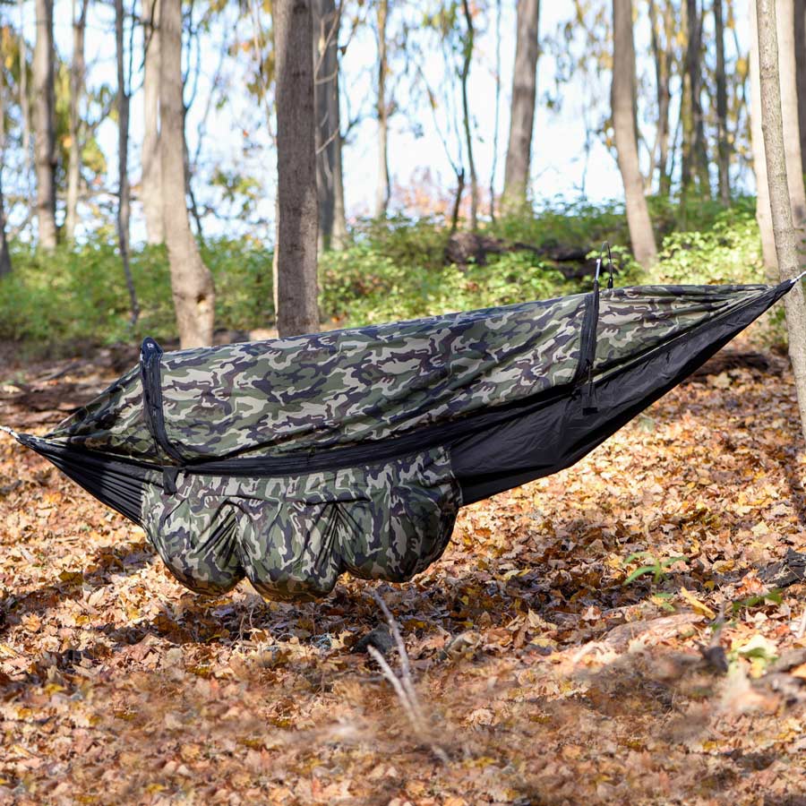 Clark NX-270 in Camo/Black hung between trees in an autumn forest