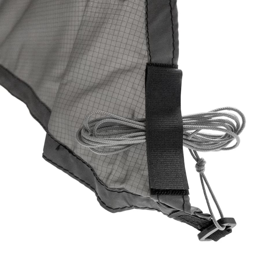 Tie-out cord stowed at a corner of the Vertex Tarp X